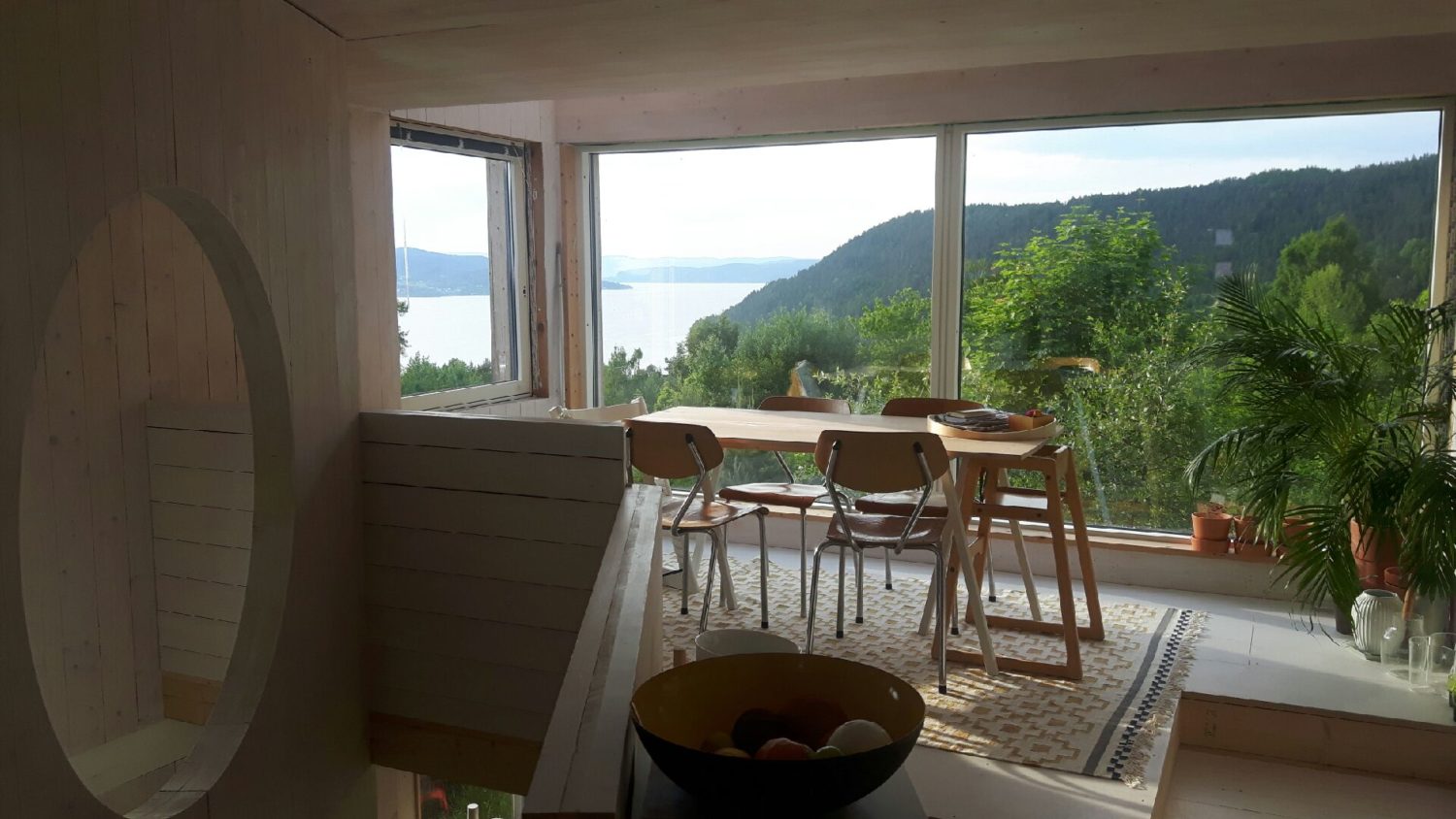 view of the main living room with big windows towards the fjord.