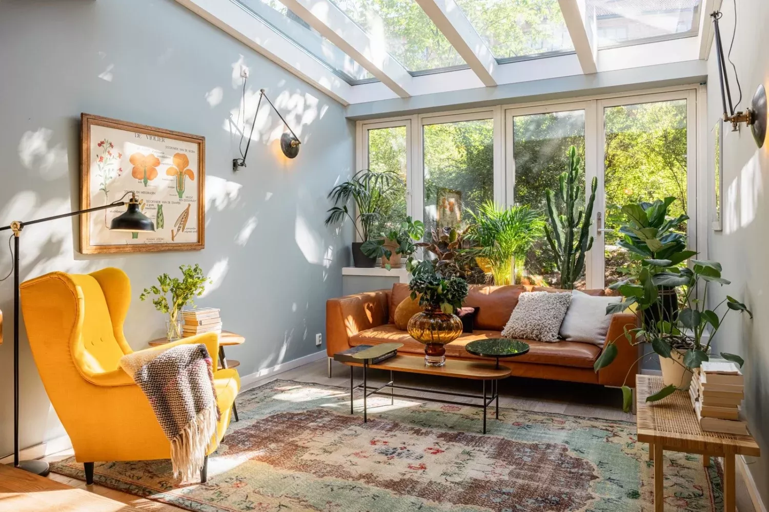 skylight over livingroom and big windows bring light and greenery into the interior