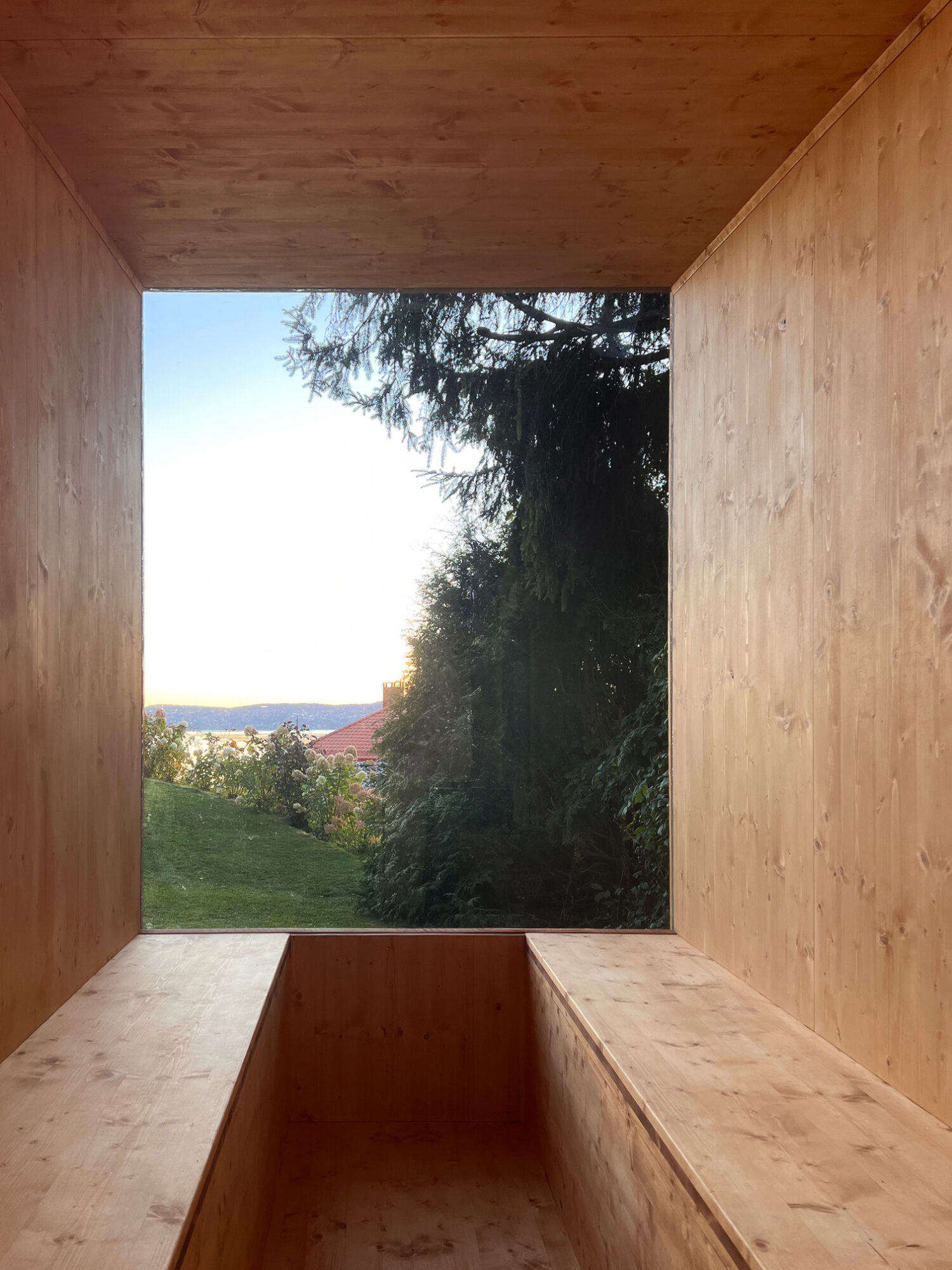 interior picture showing CLT interior of sauna and big window framing views